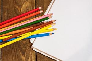 table set with colorful pencils photo