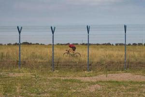 Biycle rider on cyclocross bike training outdoor on gravel country road photo