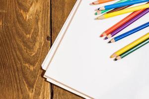 table set with colorful pencils photo