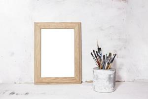 Blank photo frame with paint brushes decoration