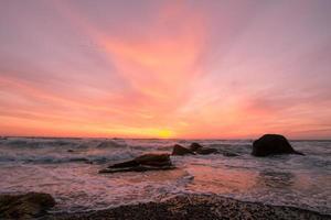 beautiful sea landscape in sunrise time, colorful pink and orange sky and storm in the sea. photo