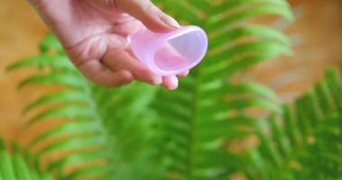 Close up of menstrual cup in woman hands. Zero waste and eco friendly concept video