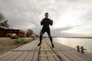 young woman athlete training outdoor in cold weather photo