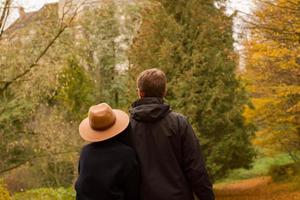 couple of tourist walking having good time in autumn park photo