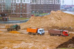 Concrete building in progress with cranes photo