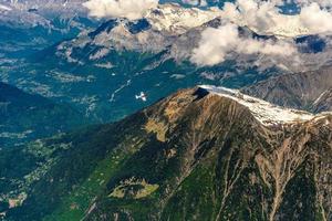 Plane flying above mountains Chamonix, Mont Blanc, Haute-Savoie, Alps, France photo