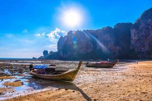 Low tide water and boats in sunset on Tonsai Bay, Railay Beach,