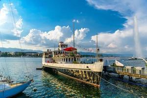 Ship in clear Geneva lake in Switzerland photo