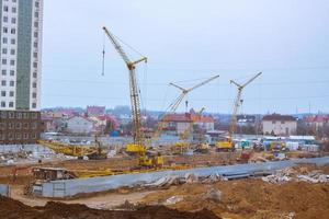 Concrete building in progress with cranes photo