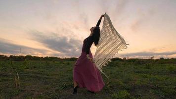 Happy female dance in the summer fields during beautiful sunset photo