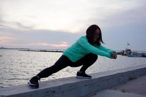 young woman athlete training outdoor in cold weather photo