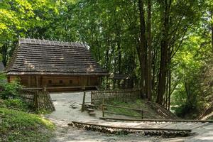 antigua casa de madera en el bosque de verano, arquitectura vintage ucraniana foto