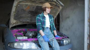 Female mechanic fixing car in a garage video