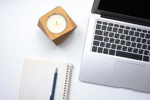 notebook on white table with gadgets and decorations, top view of writer, freelancer or buisinessman work place photo