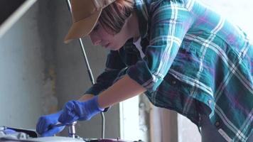 Female mechanic fixing car in a garage video