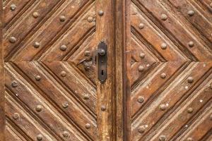 Close up of old vintage wooden door with metal furniture photo