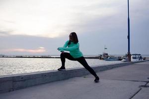 young woman athlete training outdoor in cold weather photo