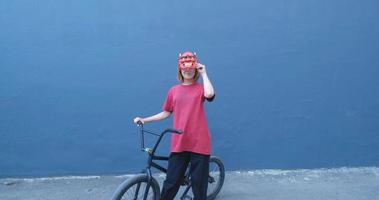 Young woman posing with BMX bicycle outdoor on the street video