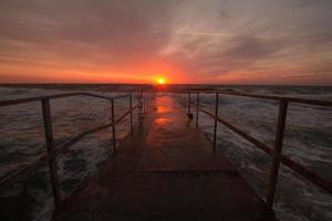 beautiful sea landscape in sunrise time, colorful pink and orange sky and storm in the sea. photo