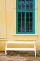 facede of old european house in yellow and turquoise colors photo