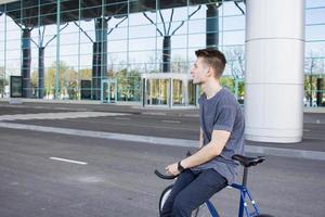 hombre ciclista montando bicicleta retro deportiva de piñón fijo. foto