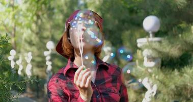 Young woman play with soap bubbles outdoors video