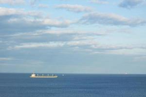 Landscape with cargo ships on horizon photo