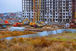 Concrete building in progress with cranes photo