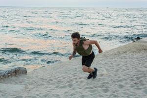 Young bearded athlete training outdoor with weighted vest, exercise with military plate carrier photo