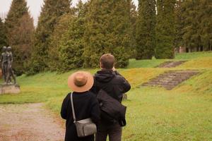 couple of tourist walking having good time in autumn park photo