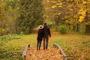 couple of tourist walking having good time in autumn park photo