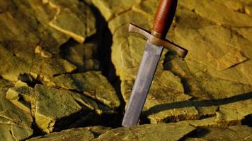 Excalibur sword in rocky stone at sunset video