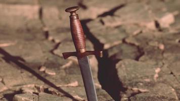 Excalibur sword in rocky stone at sunset video