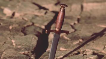 Excalibur sword in rocky stone at sunset video