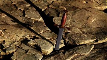 Excalibur sword in rocky stone at sunset video