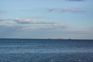 Landscape with cargo ships on horizon photo