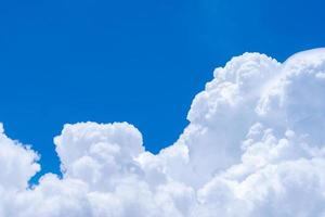 White fluffy clouds on blue sky. Soft touch feeling like cotton. White puffy cloudscape with space for text. Beauty in nature. Close-up white cumulus clouds texture background. Sky on sunny day. photo