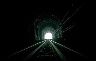 Train tunnel. Old railway in cave. Hope of life in the end of the way. Railroad of locomotive train in Thailand. Old architecture. Railway tunnel built in 1914. Travel and hope at the destination. photo