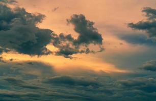 Sunset sky with gray and golden clouds. Gray sky and fluffy clouds. Thunder and storm sky. Sad and moody sky. Dead abstract background. Cloudscape. Peaceful and tranquil background. Beauty in nature. photo