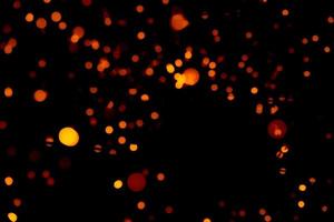 Christmas and happy new year decoration light. Red and orange color bokeh background with beautiful pattern. Defocused Xmas light in the night of party. Christmas holiday bokeh background. photo