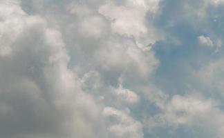 White fluffy clouds on blue sky. Soft-touch feeling like cotton. White puffy cloudscape. Beauty in nature. Close-up white cumulus clouds texture background. Pure white clouds. photo