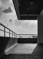 Balcony of contemporary architecture. Modern terrace of apartment. Outside the building. Balcony decorate with ceiling lamp and spotlight. Ornamental plant pot placed at veranda with sunshine. photo