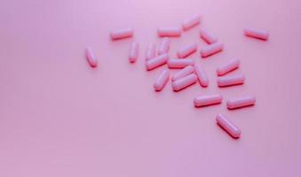 Pink capsules pill on pink background. Vitamins and supplements. Online pharmacy. Pharmacy store banner. Pharmaceutical industry. Woman's health insurance concept. Pills for love and happy life. photo