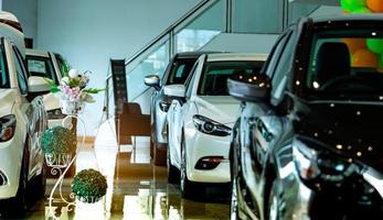 New luxury shiny compact car parked in modern showroom. Car dealership office. Car retail shop. Electric car technology and business concept. Automobile rental concept. Automotive industry. Promotions photo