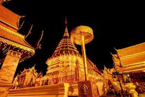 Wat Phra That Doi Suthep. Buddhist temple in Chiang Mai, Thailand. Tourist travel destinations in the north of Thailand. Wat Phra That Doi Suthep is landmark in Chiang Mai. Golden temple in the night. photo