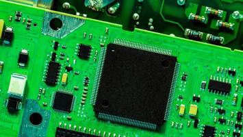 Electronic circuit board. Semiconductor motherboard circuit board technology. Mainboard of computer. Integrated semiconductor microchip on green circuit board. Hi-tech and semiconductor industry. photo