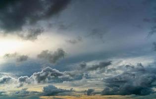 Sunset sky and gray and golden clouds. Gray sky and fluffy clouds. Thunder and storm sky. Sad and moody sky. Dead abstract background. Cloudscape. Peaceful and tranquil background. Beauty in nature. photo