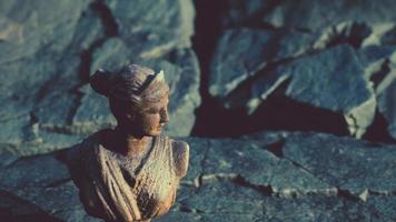 ancient statue of woman on rocky stones video