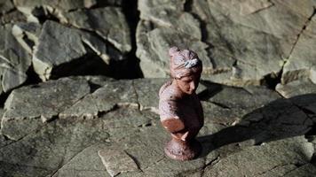 ancient statue of woman on rocky stones video