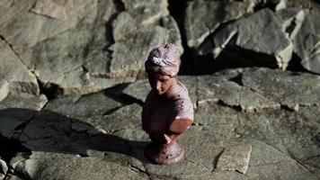 ancient statue of woman on rocky stones video
